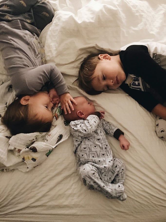 Siblings on a Bed